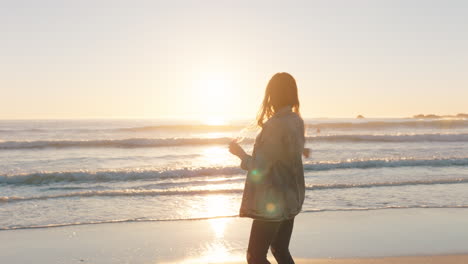 teenage girl blowing bubbles on beach at sunset having fun on vacation by the sea enjoying summer