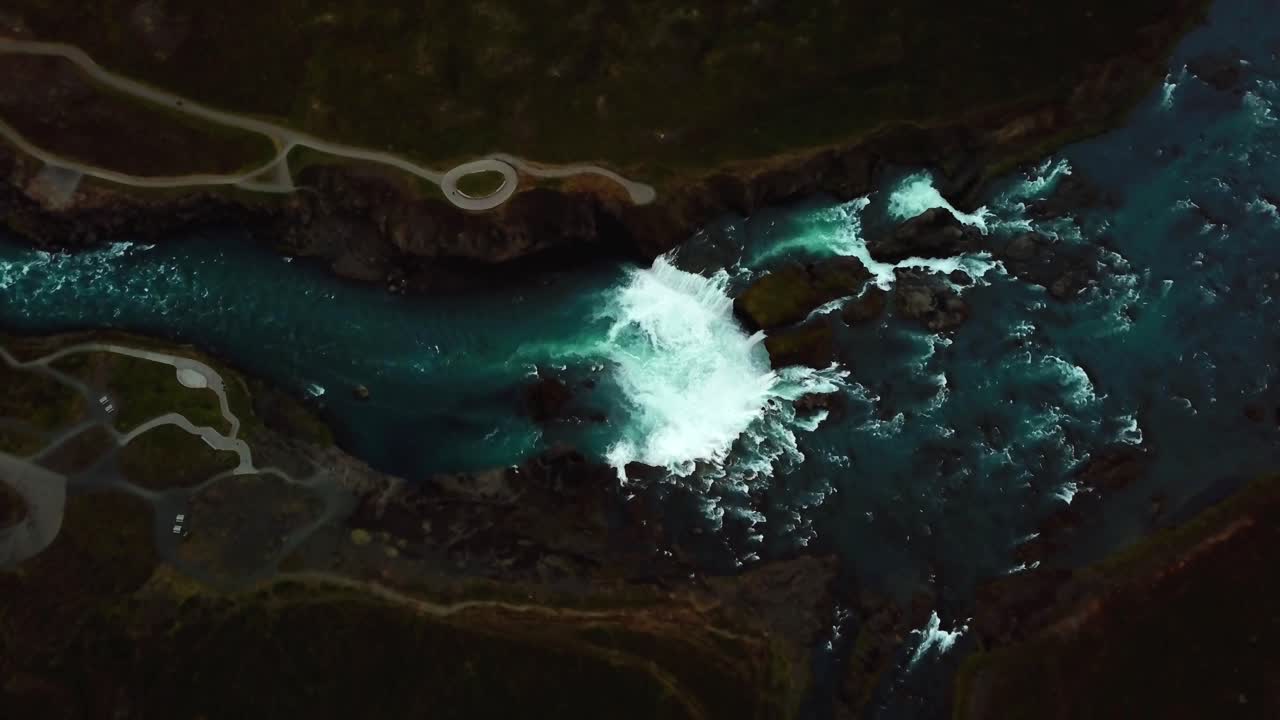 Aerial top view over Godafoss waterfall, Iceland, on a dark and cloudy day