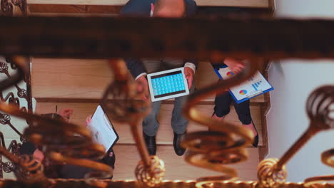 Top-view-of-businesswoman-holding-clipboard-discussing