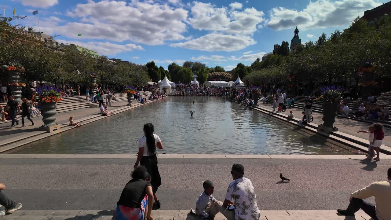 People Relax In Famous Park Kungstradgarden In Stockholm, Sweden. Slow Motion Shot