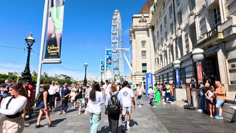 crowds walking near the london eye