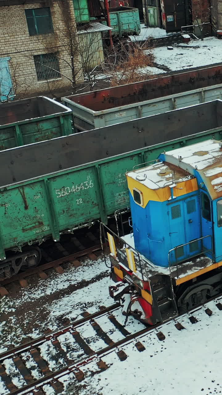 Industrial conceptual scene with trains. Aerial view of freight train on the railway station. Vertical video