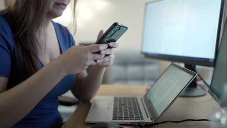 woman using smartphone at desk, aerial view