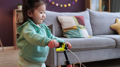 asian baby riding a bike