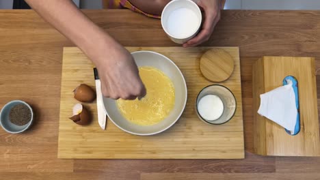 mixing eggs and milk for breakfast