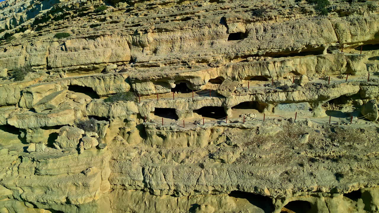 Ancient cliffside caves at venetian fortezza castle, showing unique rock formations, aerial view