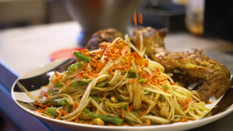 Bean-thread-noodle-stir-fry-garnished-with-fried-garlic,-slow-motion-close-up-4K