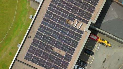 rising overhead aerial video of a solar panel array filmed on a bright and sunny day. produced in 4k, 30fps and with rec709 color