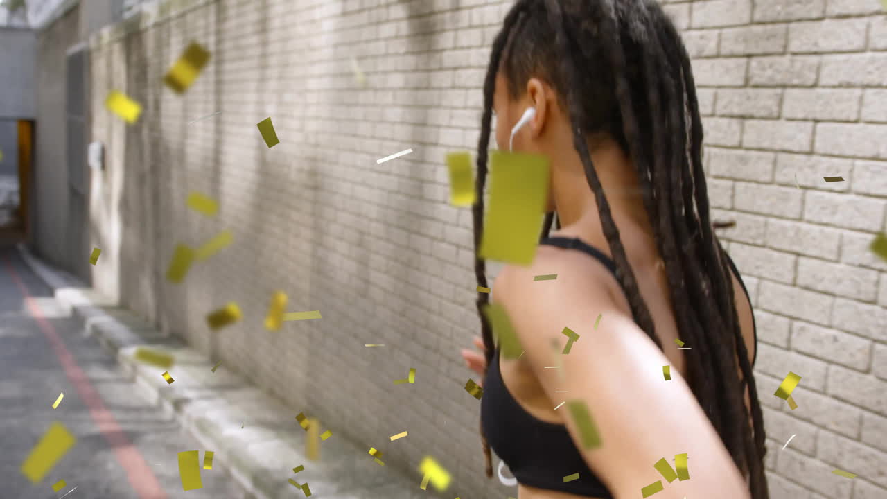 골목길을 고, 금색 콘페티 애니메이션으로 둘러싸인 드레드록을 가진 사람