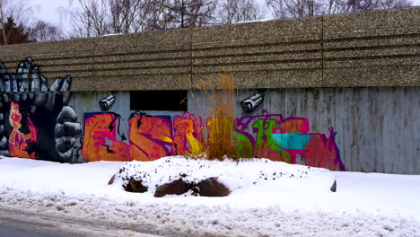 graffiti on walls in empty snowy street