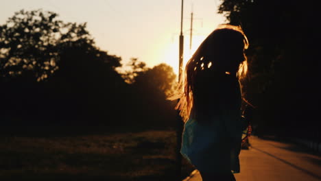 Silhouette-Of-A-Girl-Having-Fun-Running-Down-The-Alley-In-The-Rays-Of-The-Setting-Sun