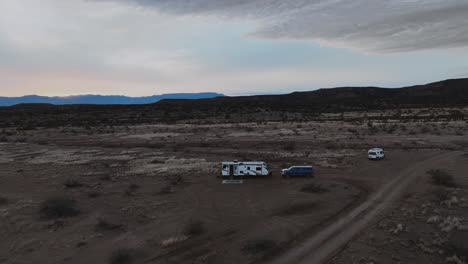 Camper-Van-In-Desert-Landscape-Of-Sedona,-Arizona-At-Sunset---Aerial-Pullback