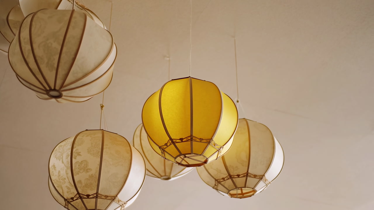 Warm Yellow And White Lanterns Suspended Over Boutique Caf Ceiling, Glowing Paper Shades Casting Soft Ambient