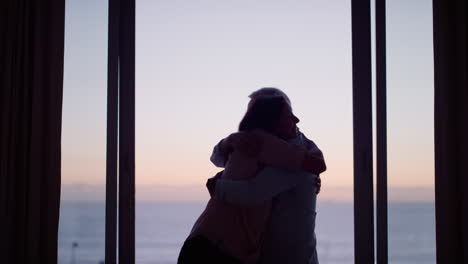 silhouette-happy-old-couple-dancing-in-hotel-room-celebrating-anniversary-retirement-on-vacation-enjoying-successful-marriage-having-fun-dance-at-sunset