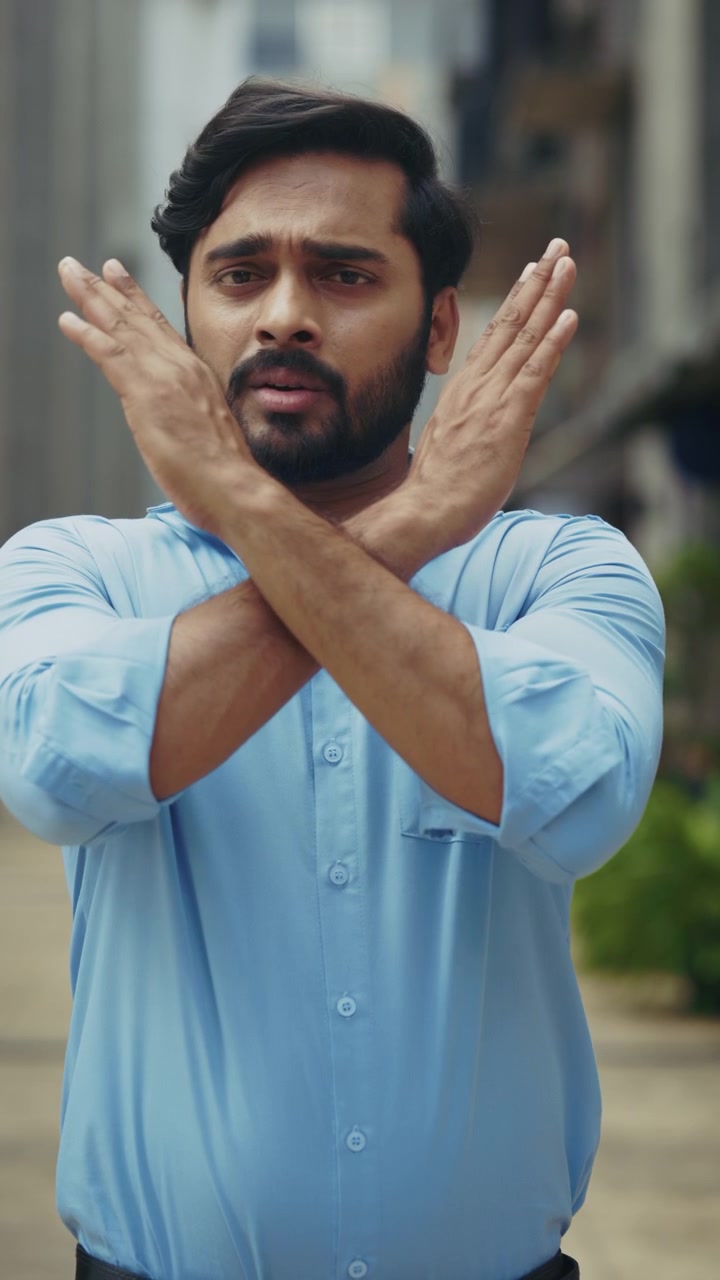 Man expressing denial with crossed arms