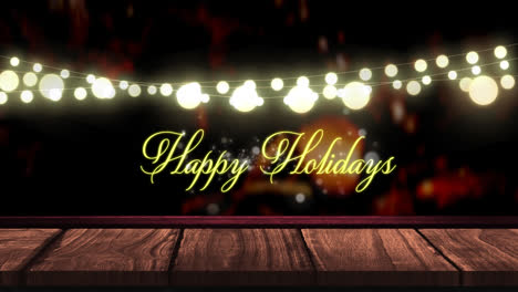 Animation-of-fairy-lights-and-happy-holidays-text-over-wooden-boards