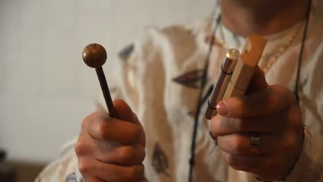 close up of a man's hands using a energy bar chime