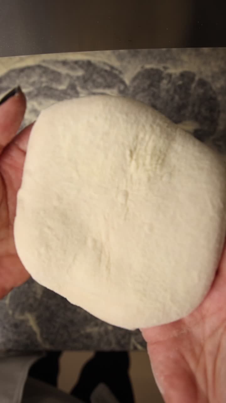 Hands Holding Fresh Dough