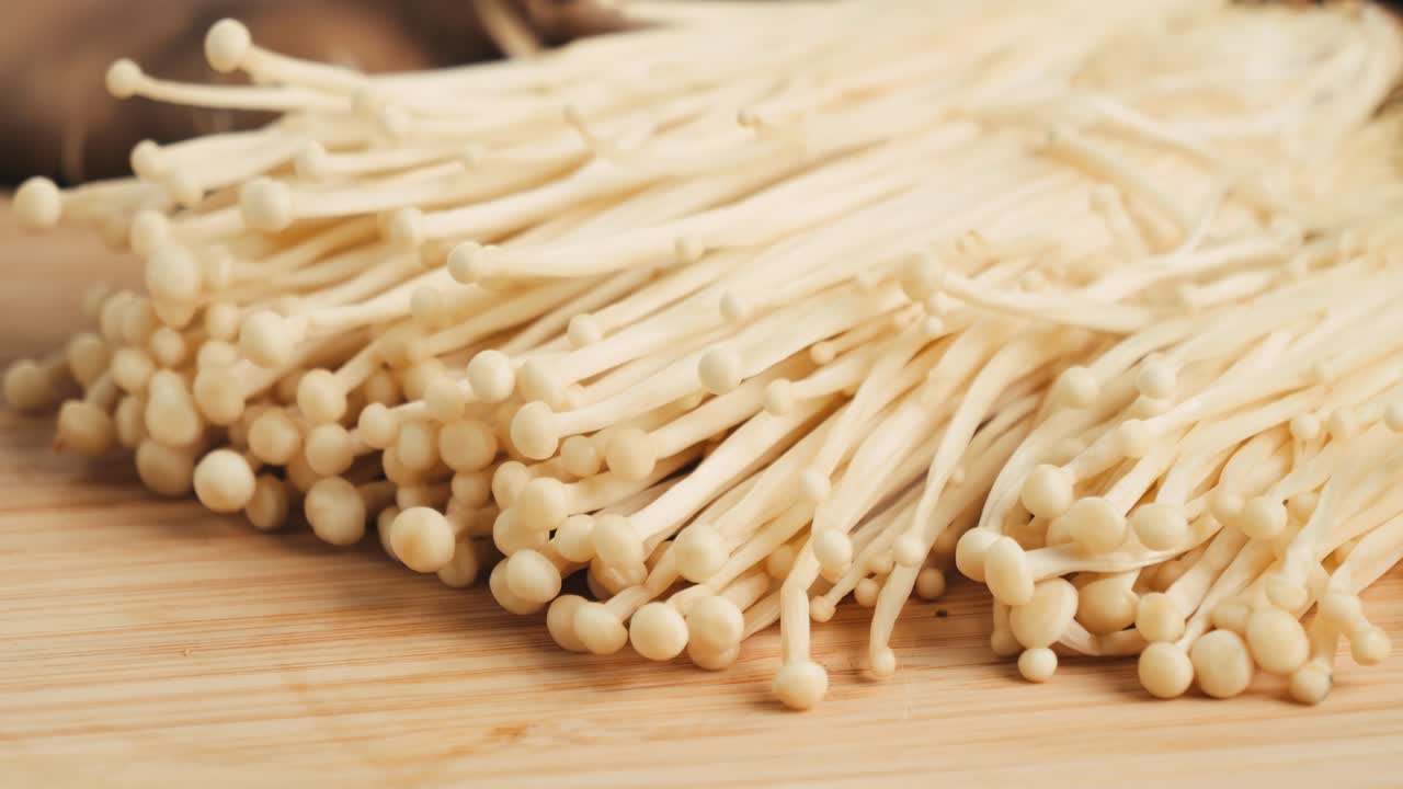 Fresh Enoki Mushrooms on a Wooden Cutting Board