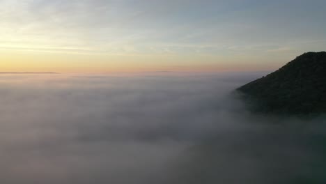 sunrise over misty mountains