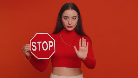 woman holding a stop sign