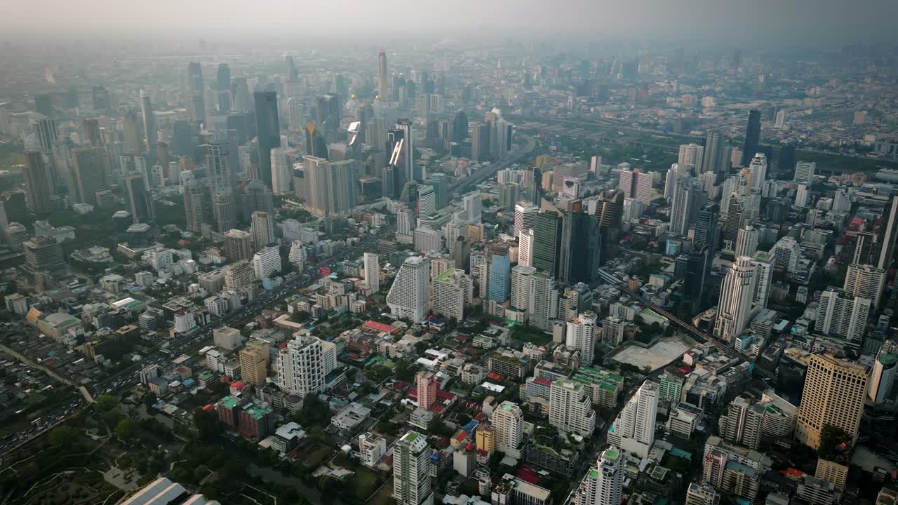 Aerial Scenic Drone Footage of the Skyline of Downtown Bangkok, Thailand Covered in Smog during Sunset during the Smokey Burning Season