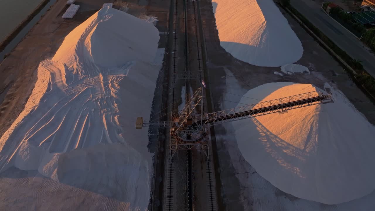 Salt plant and patterned flats under golden light, Greece