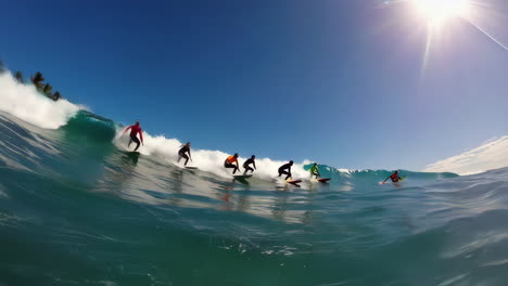 surfers riding waves on a sunny tropical day