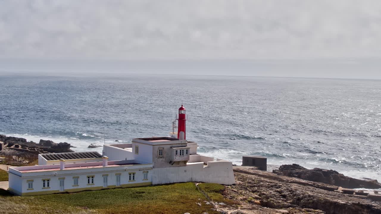 Coastal lighthouse on the cliffs of Portugal overlooking the ocean