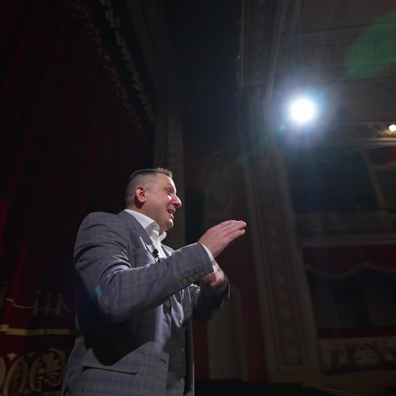 Young actor rehearsing a scene in a theater. Medium shot of an actor performing a monologue in a theater