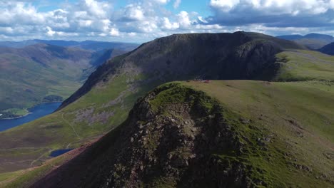 Aerial-drone-video-of-mountains-and-lake-with-scattered-clouds