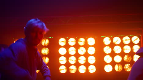 talented dancing people performing breakdance moves on modern night club stage.