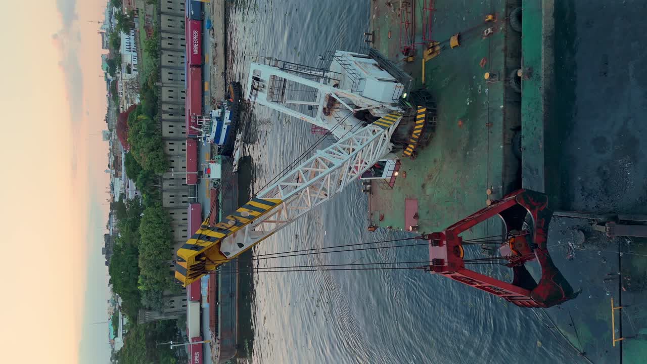 Dredging the inland river channel of the Ozama River with a crane