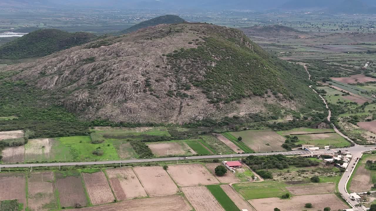 Aerial View of a Mountainous Rural Landscape with Agricultural Fields and Road
