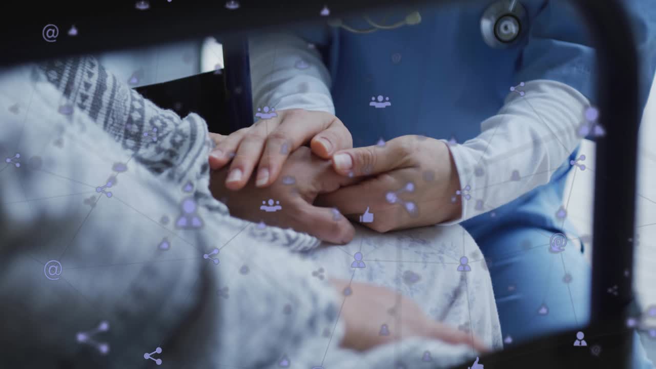 Doctor reaching patient's hand, interlacing fingers and comforting with drifting social icons