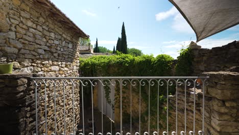 Slow-dolly-shot-over-the-balcony-of-a-villa-in-Nimes-with-a-canopy-for-the-sun