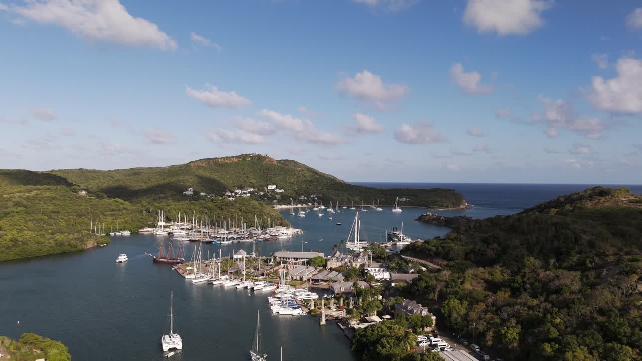 English Harbor with yachts and boats docked in scenic Nelson’s Dockyard Antigua under a blue sky