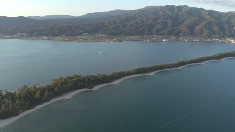 Kyoto-by-the-Sea,-Amanohashidate-Pine-Sand-Bar-Across-Ocean-Aerial-View