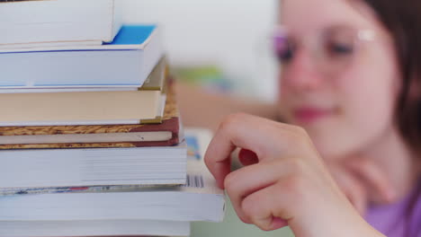 a young student counts the number of books to read