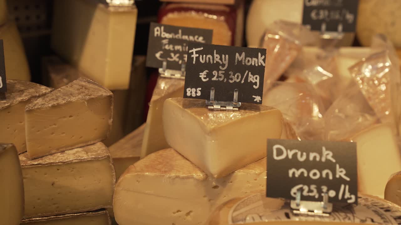 A wide variety of cheeses on display at a market
