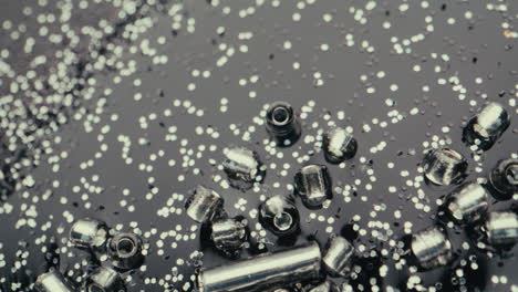 shiny silver beads and glitter on dark background