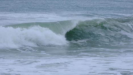 closeup of frothy whitewash waves rolling and crashing into beach in southern sri lanka