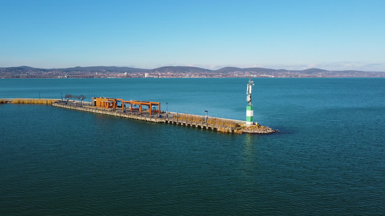 Wide aerial of boat pier and ferry terminal near Hajokikoto in Lake Balaton under blue skies