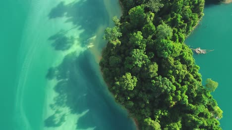 a bird'seyeview shows a tourist enjoying the waters at khao sok national park in surat thani thailand