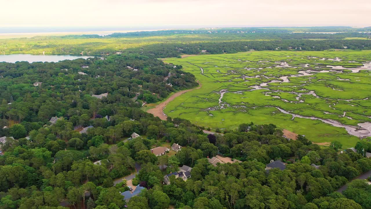 Drone video of Maine tidal marsh highlights curving channels, saltwater pools, and grassy wetlands meeting sandy banks, showcasing the rugged beauty of New England’s coastal ecosystem