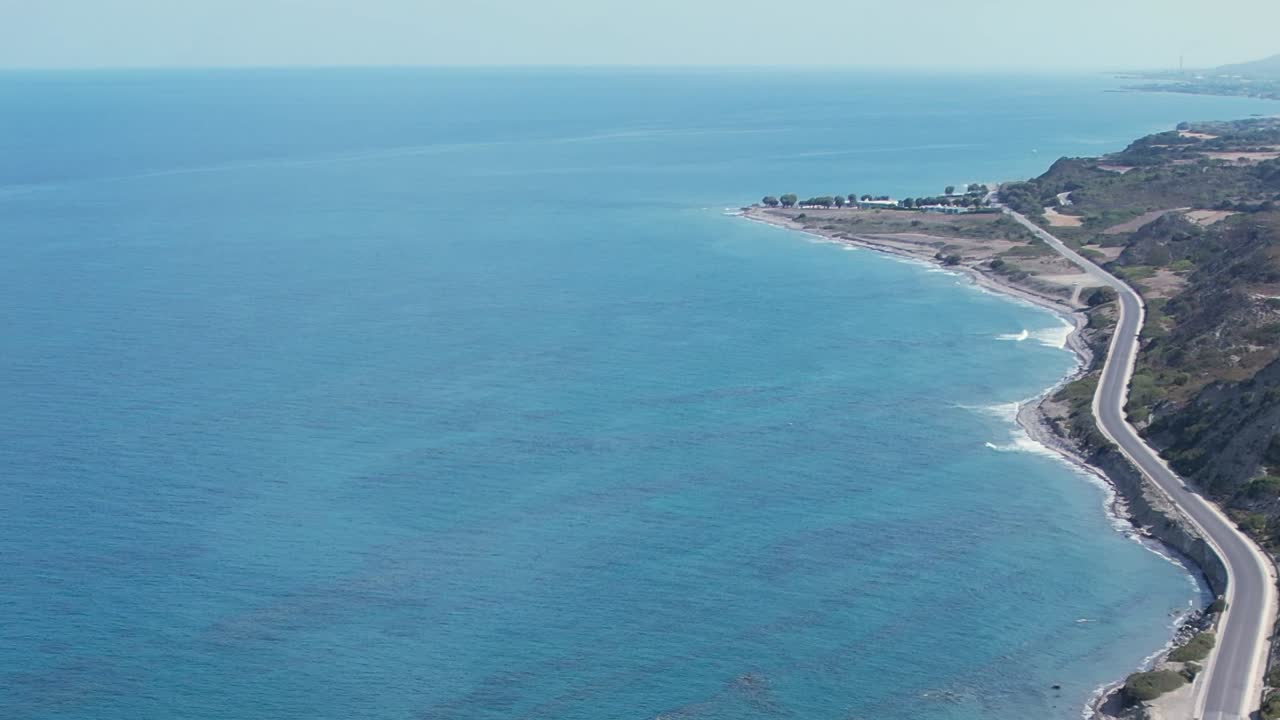 Coastal highway along the blue waters of Greece on a sunny day