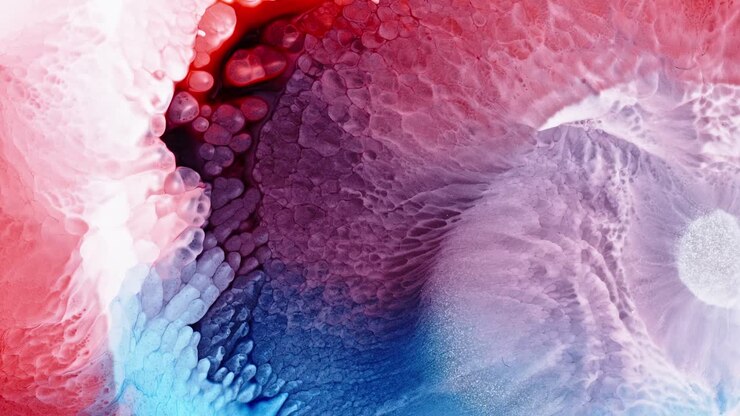 Abstract red and blue ink clouds merging in water, creating a vibrant, dynamic mix of colors with a fluid, ethereal appearance