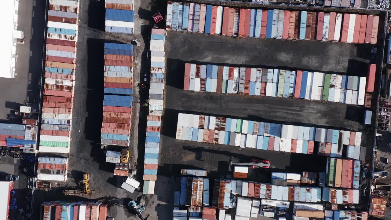 Colorful containers waiting for shipment seen from above at storage yard, aerial