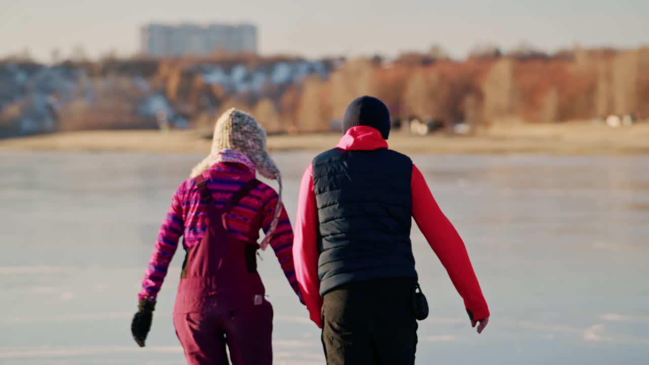 Couple Ice Skating on a Frozen Lake in Winter