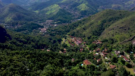 aerial view of a town nestled in a lush green mountain valley